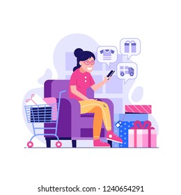 Happy woman purchasing with mobile phone on internet digital store. Korean girl shopping online at home. Smiling customer with shopping cart making online order on sofa buying gifts and clothes.