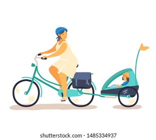 Happy woman riding a bicycle with a young girl sitting in a pull behing bike trailer. Urban family cycling and bike helmet safety topics. 