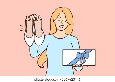 Happy woman showing new shoes and box with gift bow boasting purchase after shopping. Positive girl demonstrates gift footwears from boyfriend rejoicing at attention and care