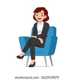 Happy woman sitting in armchair wearing suit looking friendly with crossed legs pose