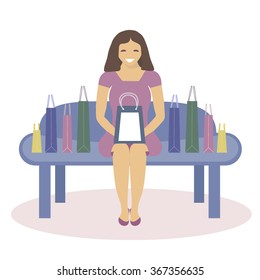 Happy woman sitting with shopping bags