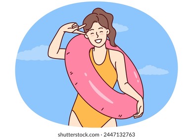 Happy woman in swimsuit for sunbathing and swimming in ocean rejoices in long-awaited summer vacation and holds lifebuoy. Girl tourist in bathing suit for beach or pool is resting on tropical island