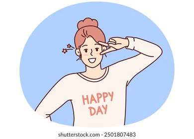 Happy woman waving hand demonstrating letter V with fingers and looking at camera wishing you happy day. Woman with happy day lettering on t-shirt as sign of greeting makes victory gesture