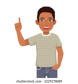 Happy young African man with hand in pocket showing presenting pointing finger to copy space for product advertisements