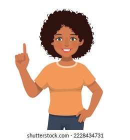 Happy young African woman with hand on waist showing presenting pointing finger to copy space for product advertisements