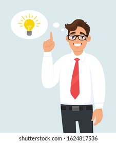 Happy Young Business Man Pointing Up. Light Bulb Representing Idea, Solution In The Thought Bubble. Trendy Person Thinking, Gesturing Or Showing Index Finger. Vector Illustration In Cartoon Style.