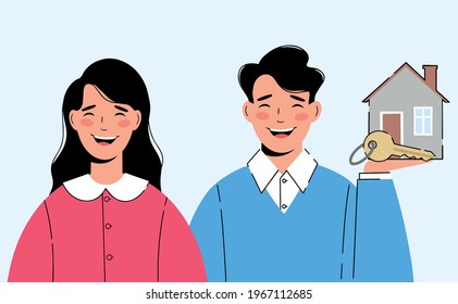 Happy young couple. Man is holding a new house and a key symbolizing the purchase of a house.