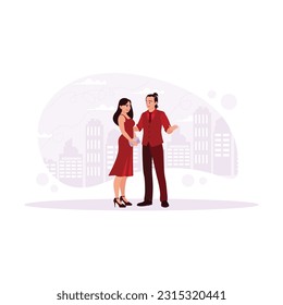 La feliz pareja joven, una mujer con un vestido y zapatos elegantes y un hombre con una camisa y unos zapatos geniales. Reúnanse unos a otros frente a hermosos edificios altos. Ilustración plana vectorial moderna de tendencia.