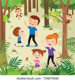 Happy Young Family Hiking In The Forest