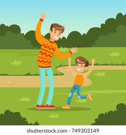 Happy young family and son playing games in city park