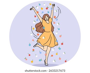 Happy young girl raises hands standing on one leg, experiencing joy and positive emotions from summer weather. Cheerful girl in short dress stands among flowers enjoying sunny day