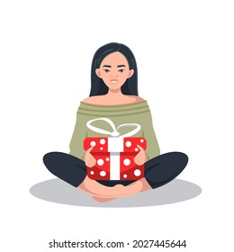 A happy young Korean woman is sitting in the lotus position and holding a gift box with a bow in her hands. Vector. The concept of a gift for congratulations on a birthday, Christmas, Holidays.