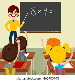 Happy young male teacher standing asking maths lesson to children raising hands up sitting in classroom