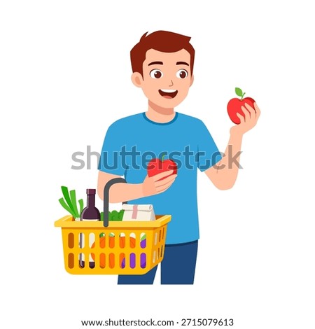 Happy Young Man Holding Two Red Apples and a Shopping Basket Filled with Groceries Smiling and Looking Pleased