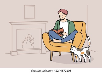 Happy young man sit in chair at home near fireplace reading book. Smiling guy relax in armchair enjoying literature. Hygge and domestic weekend. Vector illustration. 