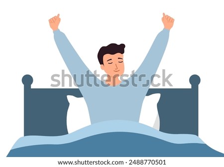 Happy young man stretch waking up in home bedroom. Smiling guy with good morning in bed.