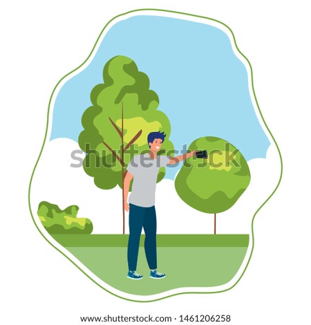 happy young man taking a selfie in the park