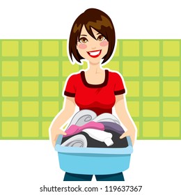 Happy young woman holding clothes laundry chores basket