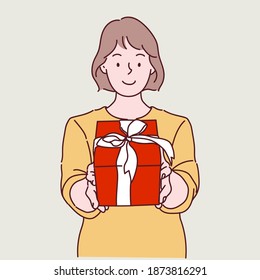 Happy young woman holding a gift box, Christmas and New year celebration. Hand drawn in thin line style, vector illustration.
