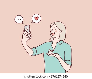 happy young woman look at the smartphone and smile. Hand drawn style vector design illustrations.