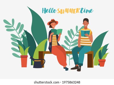 Happy young woman and man reading book in the garden.  Agriculture gardener hobby