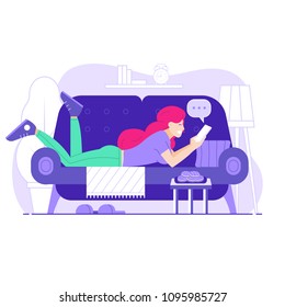 Happy young woman on sofa with smartphone chatting on social media and receiving messages or mail. Red headed girl lying on couch relaxing with phone in hands and using mobile internet.