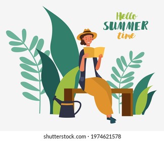Happy young woman reading book in the garden. Agriculture gardener hobby