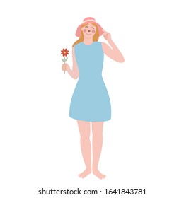 The happy young woman in summer clothes with one red flower in her hand is isolated on the white background.