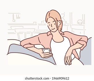 Happy young woman using mobile phone while sitting a couch. Hand drawn style vector design illustrations.