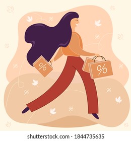 Happy young woman walks from a shopping mall with bags full of purchases. Seasonal sales. Autumn discounts. Black friday concept.