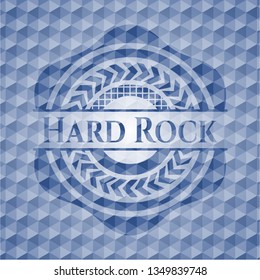 Hard Rock blue emblem with geometric pattern background.