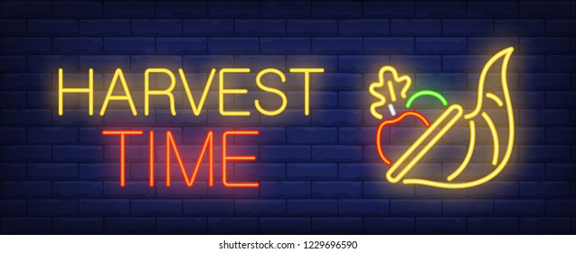 Harvest time neon text with vegetables. Thanksgiving Day advertisement design. Night bright neon sign, colorful billboard, light banner. Vector illustration in neon style.