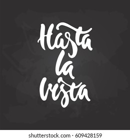 Hasta la vista - hand drawn spanish lettering phrase, that means See you on the black chalkboard background. Fun brush ink inscription for photo overlays, greeting card or print, poster design