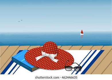 Hat, book and glasses on sea landscape