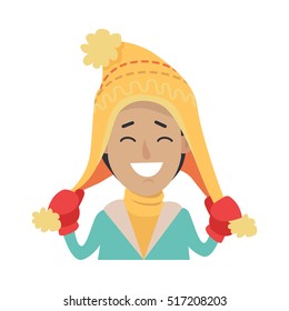Hat. Happy smiling boy with yellow cap on head. Male holding endings of hat in two hands in red mittens. Knitted hat with stripes. Yellow sweater. Green jacket. White background. Vector illustration