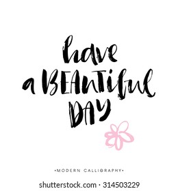 Have a beautiful day. Modern brush calligraphy. Handwritten ink lettering. Hand drawn design elements.