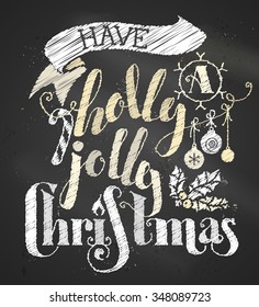 Have a Holly Jolly Christmas! Chalk hand-written lettering on blackboard background. Candy cane, Christmas baubles, ribbon and holly berry. 