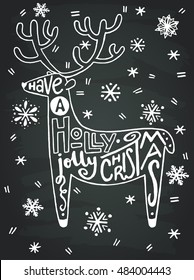 'Have a holly jolly Christmas' hand written quote in a shape of a reindeer with hand drawn snowflakes on the chalkboard background. Perfect for xmas greeting and invitation cards, flyers and poster.