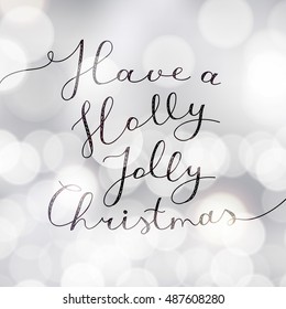 have a holly jolly christmas, vector lettering, handwritten text on blurred background with lights