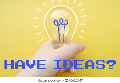 Have ideas? text. Hand holding a light bulb. Innovation and creativity concept. Vector desigh with traced photo.