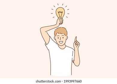 Having business idea and innovation concept. Young caucasian positive man cartoon character standing with light bulb above feeling excited vector illustration 