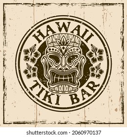 Hawaiian tiki wooden head colored vector round vintage emblem, badge, label, logo or t-shirt print. Illustration on background with grunge textures and frame vector illustration