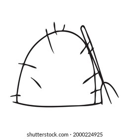 A haystack of black and white color with a pitchfork for collecting dry grass.