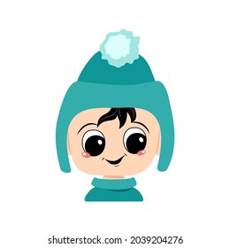 Head of adorable baby with happy emotions. Avatar of a child with big eyes and a wide smile in a blue hat with a pompom. A cute kid with a joyful face in an autumnal or winter headdress