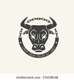 The head of an angry bullin chains. Old school  round emblem.