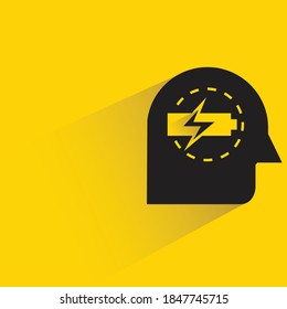 head and battery with shadow yellow background