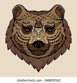 The head of the bear in the style zentangle. Patterned brown bear's head with a black lace stroke on a beige background. Vector. It may be used for design of a t-shirt, bag, postcard, a poster. Logo.