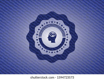head with gears inside icon inside badge with denim background