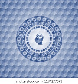 head with gears inside icon inside blue emblem or badge with abstract geometric pattern background.