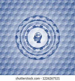 head with gears inside icon inside blue emblem with geometric pattern.